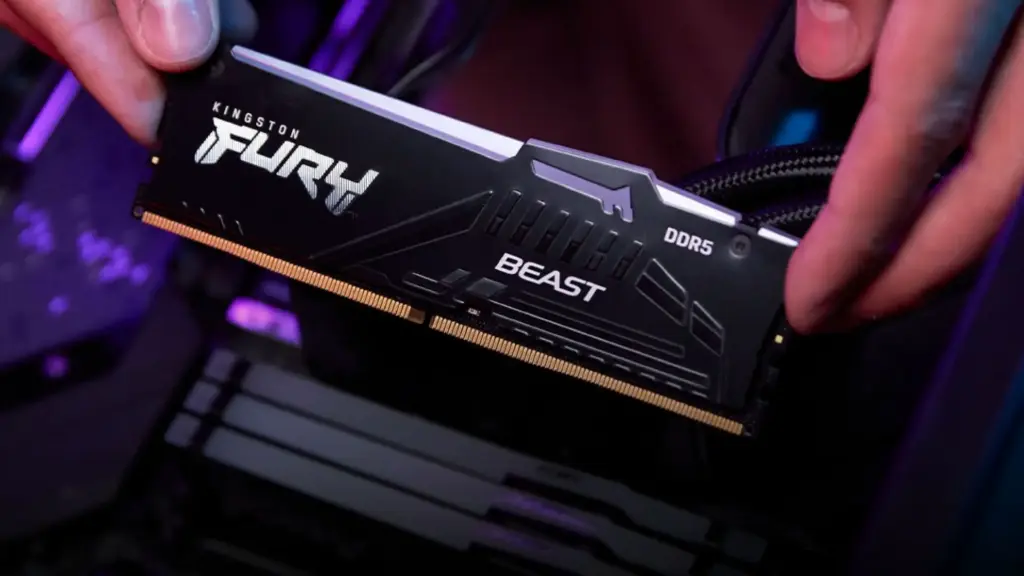 DDR5 RAM stick held in hand during PC assembly