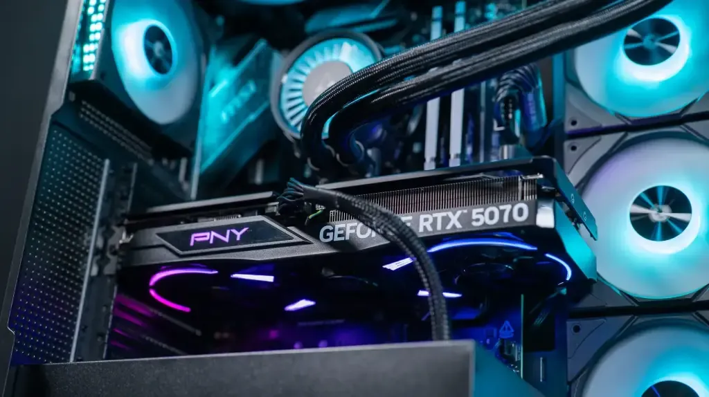 PNY GeForce RTX 5070 graphics card installed in a gaming PC with liquid cooling and ARGB fans