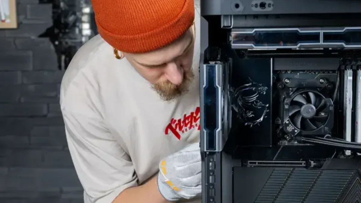 Assembly of a gaming PC in the FlowUP workshop, installing components into the case