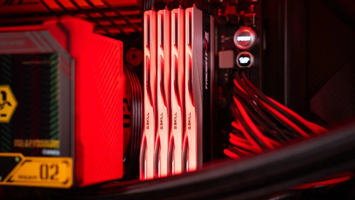 DDR5 RAM sticks next to the yellow heatsink of a motherboard