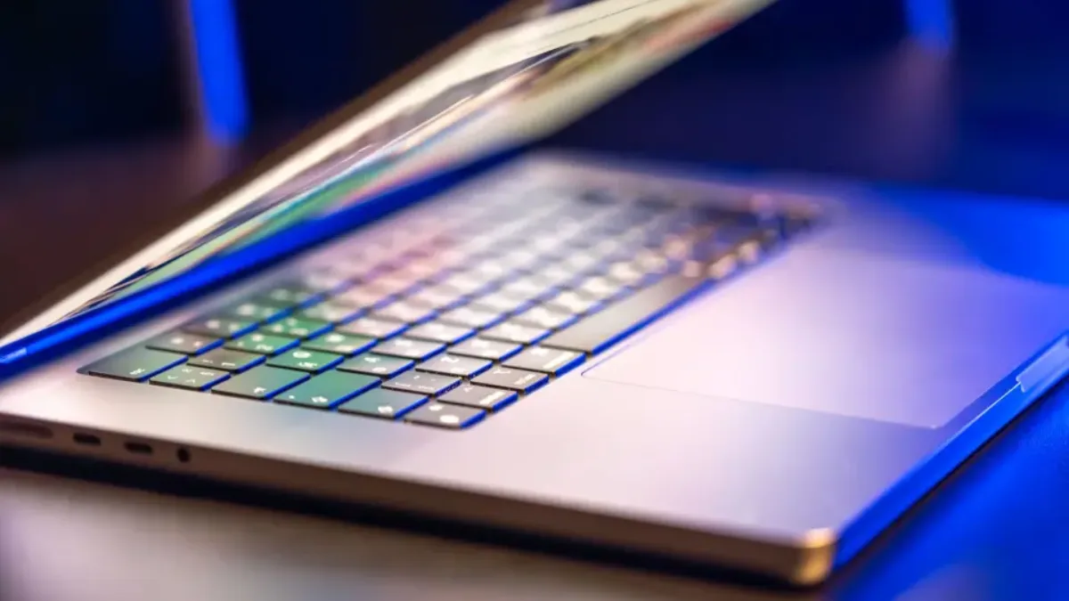 Slim, lightweight laptop slightly opened, backlit keyboard