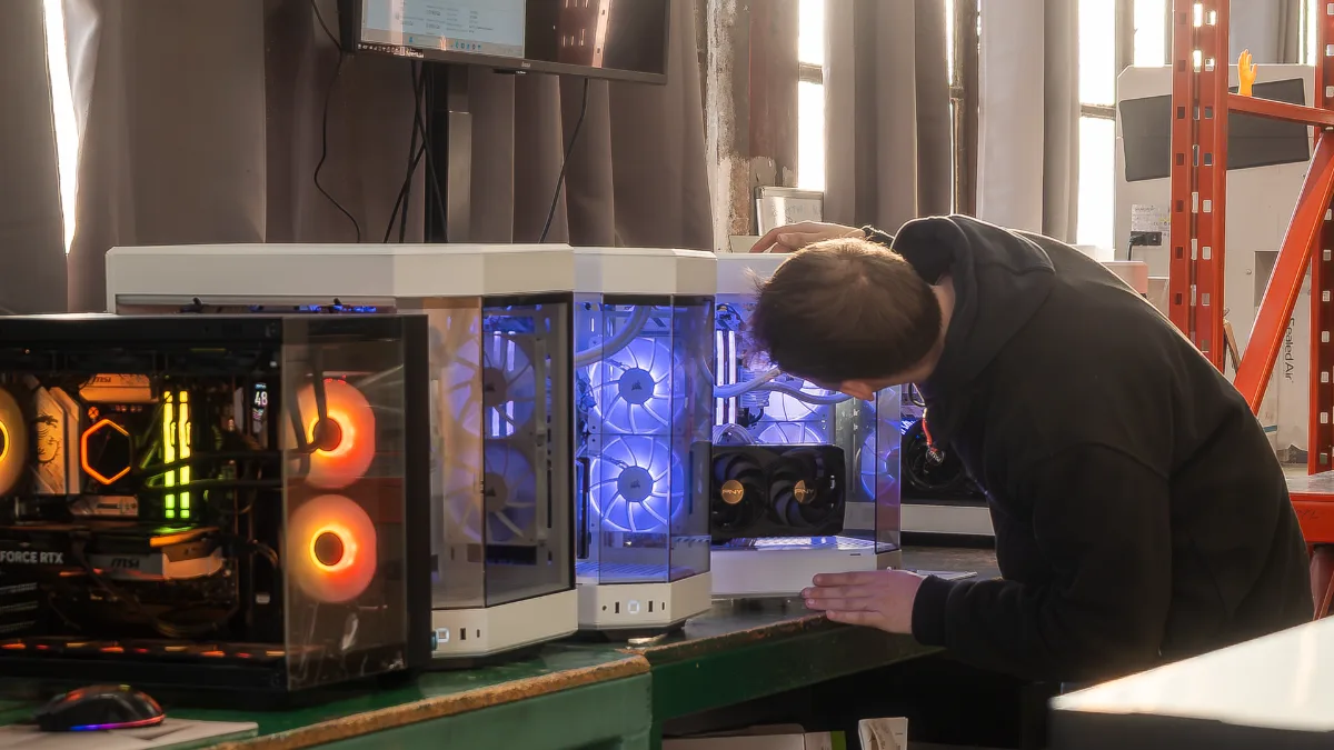 FlowUP technician checking gaming PCs in the Genappe workshop